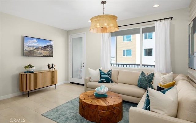 living area featuring recessed lighting and baseboards