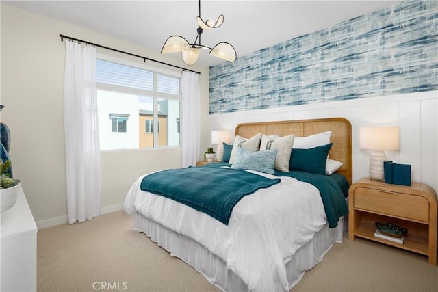 bedroom with a notable chandelier, baseboards, light colored carpet, and wallpapered walls