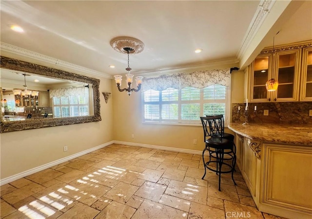 dining area featuring crown molding and a notable chandelier