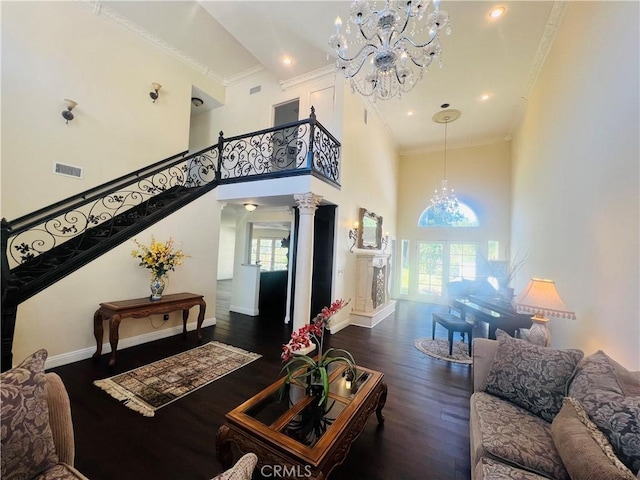 living room with plenty of natural light, dark hardwood / wood-style floors, and ornate columns