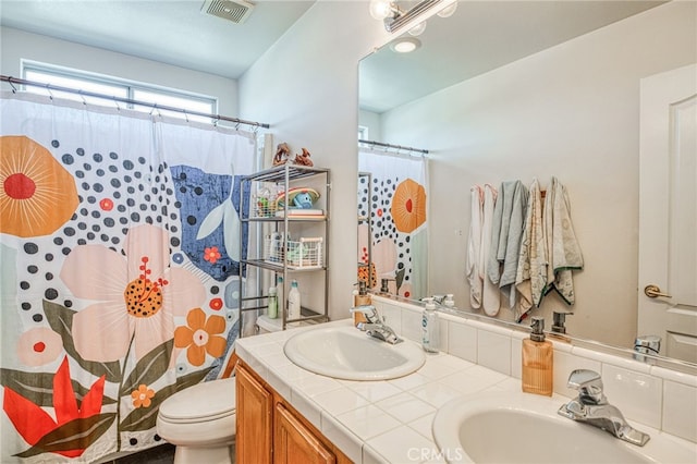 bathroom with a shower with curtain, vanity, and toilet