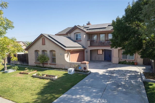 front of property with solar panels, a balcony, and a front yard