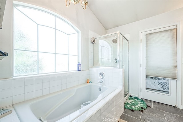 bathroom featuring plenty of natural light, independent shower and bath, and lofted ceiling