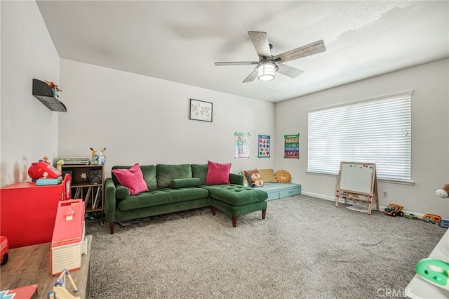 game room featuring dark colored carpet and ceiling fan