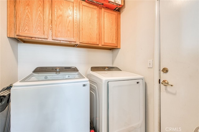 laundry area featuring cabinets and independent washer and dryer