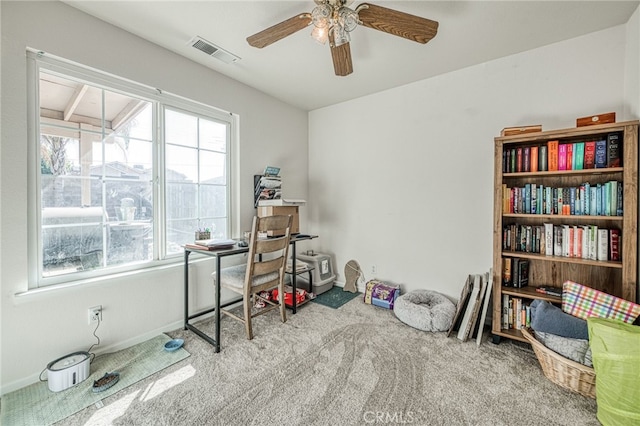 misc room with ceiling fan, a healthy amount of sunlight, and light carpet