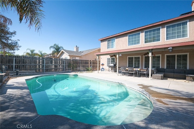 view of swimming pool featuring outdoor lounge area, ceiling fan, and a patio area