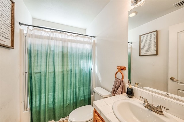 full bathroom featuring shower / bath combination with curtain, vanity, and toilet