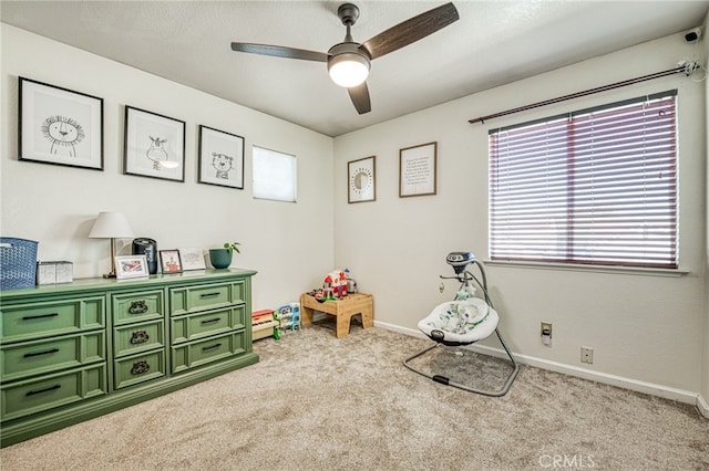 playroom featuring ceiling fan and light colored carpet