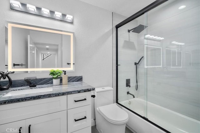 full bathroom with vanity, toilet, and shower / bath combination with glass door