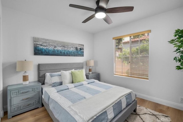 bedroom with ceiling fan and light hardwood / wood-style floors