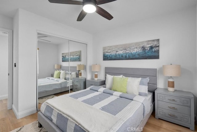 bedroom featuring a closet, light hardwood / wood-style floors, and ceiling fan