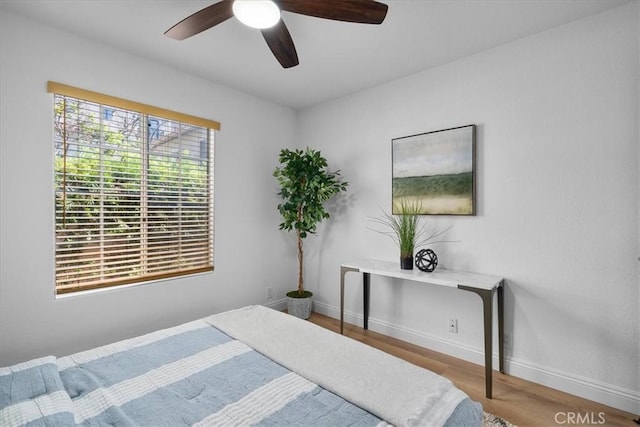 bedroom featuring hardwood / wood-style flooring and ceiling fan