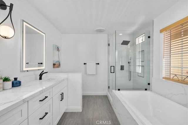 bathroom featuring plus walk in shower and vanity