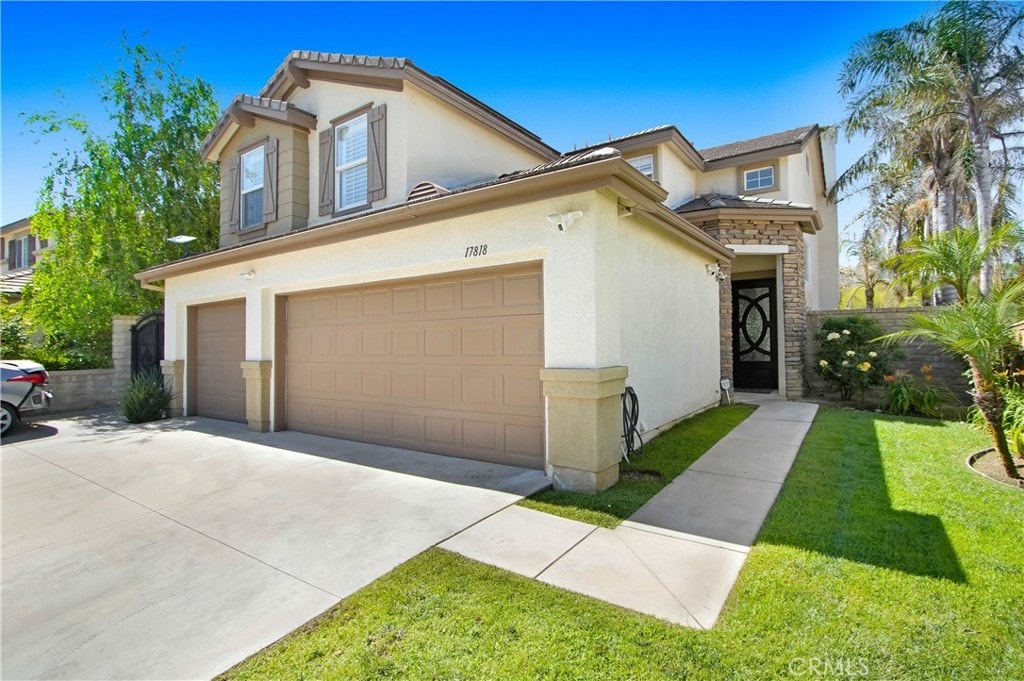 view of front facade with a garage and a front lawn