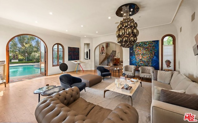 living room with light wood-type flooring and a chandelier