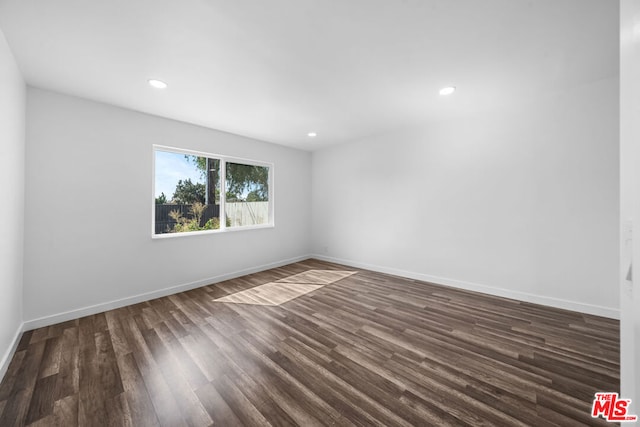 unfurnished room with dark hardwood / wood-style floors