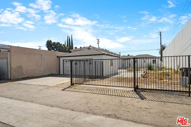 view of gate with a garage