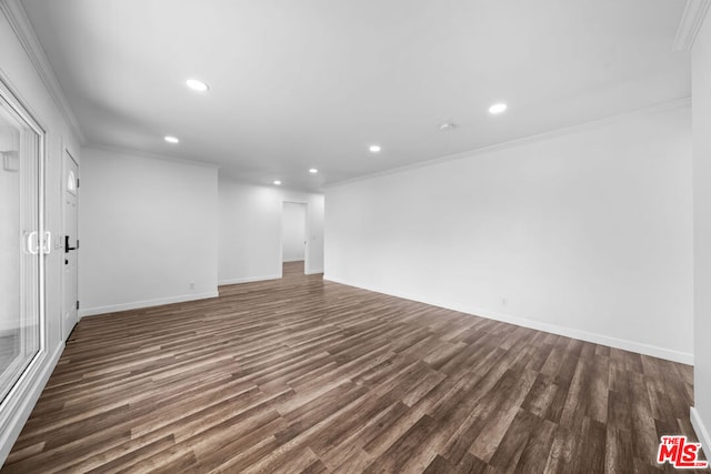 empty room featuring ornamental molding and dark hardwood / wood-style floors