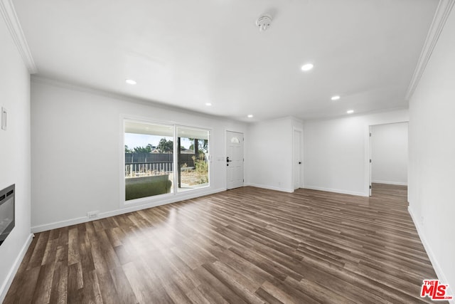 unfurnished living room featuring crown molding and dark hardwood / wood-style flooring