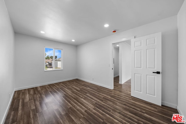 empty room featuring dark hardwood / wood-style flooring