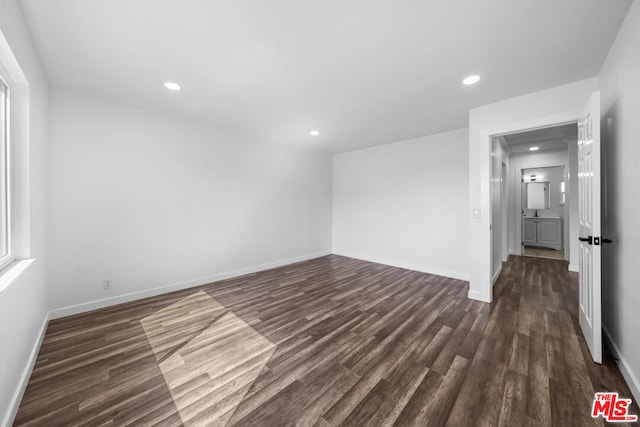 empty room with dark hardwood / wood-style floors