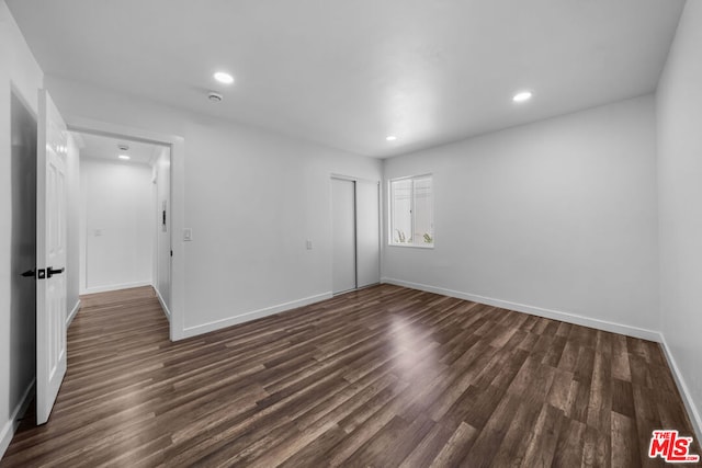 spare room featuring dark hardwood / wood-style floors