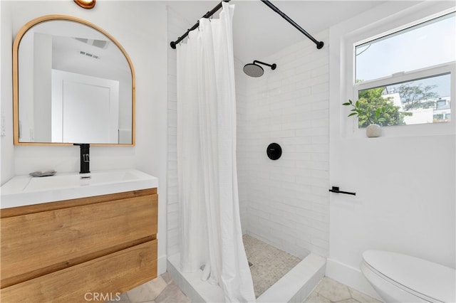 bathroom with toilet, vanity, and curtained shower