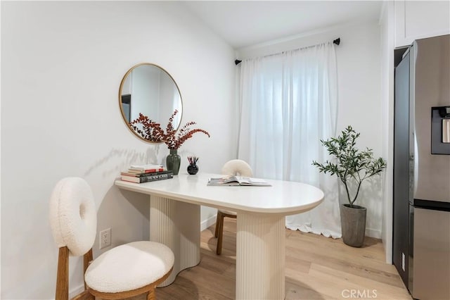 dining space with light wood-type flooring