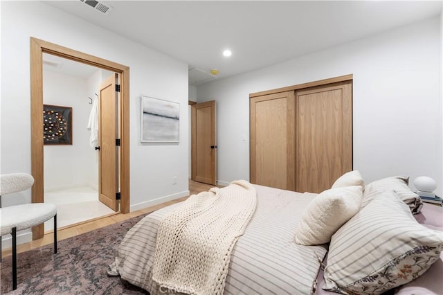 bedroom with a closet and light hardwood / wood-style flooring