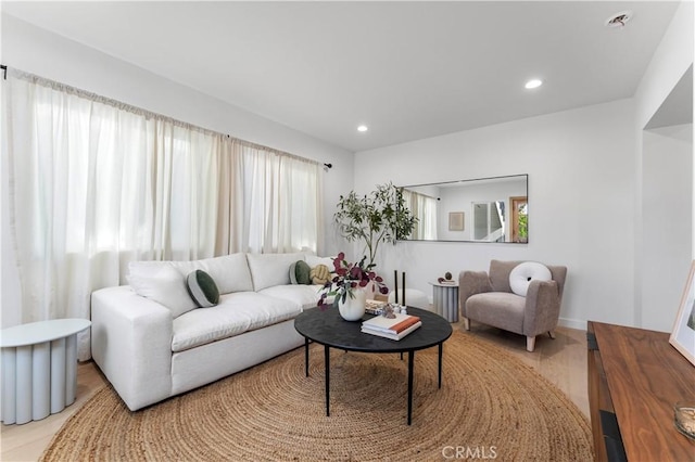 living room featuring a wealth of natural light and light hardwood / wood-style floors