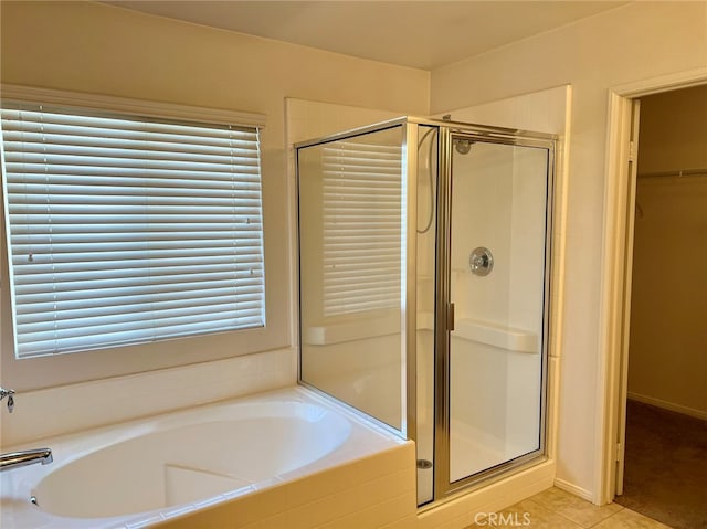 bathroom featuring shower with separate bathtub, tile patterned flooring, and a wealth of natural light