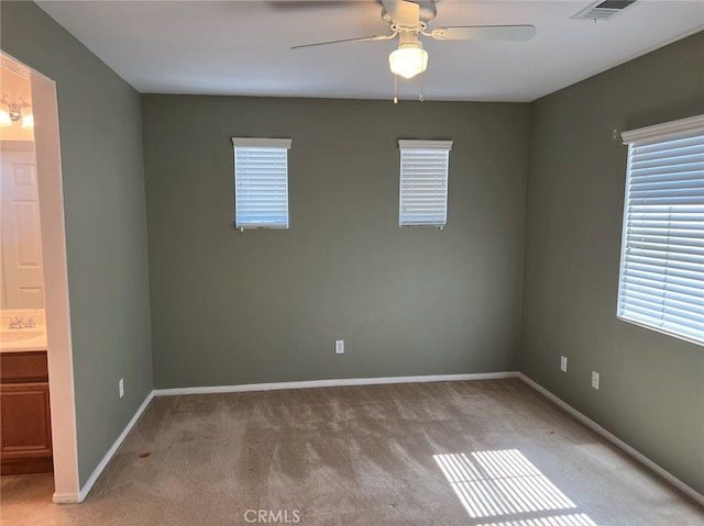 carpeted empty room with ceiling fan and sink