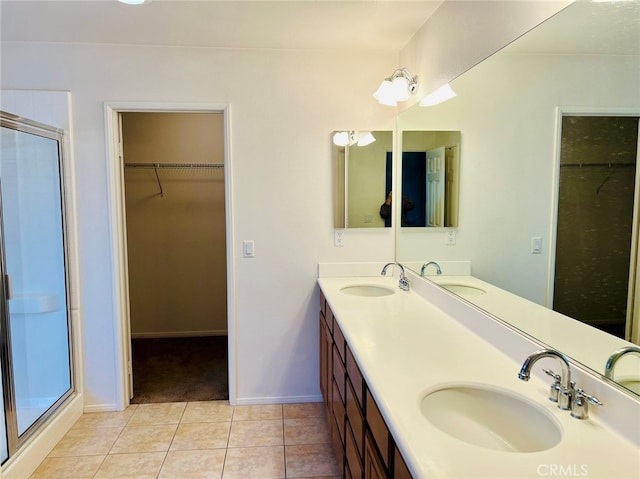 bathroom with vanity, tile patterned flooring, and a shower with door