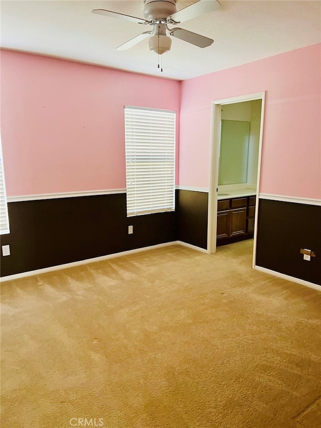 spare room with light carpet and ceiling fan