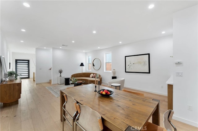 dining space with light wood-type flooring