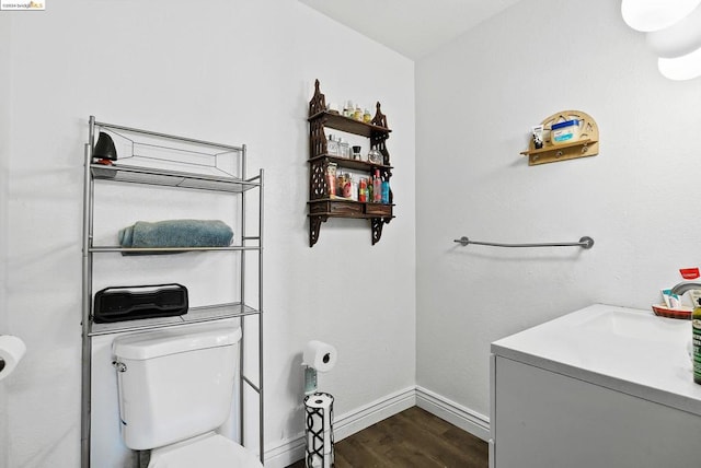 bathroom featuring vanity, hardwood / wood-style floors, and toilet