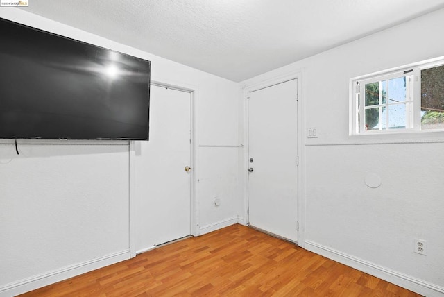 empty room with light hardwood / wood-style floors