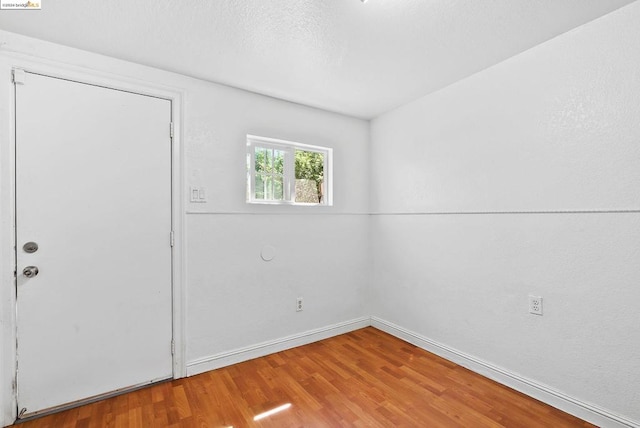 unfurnished room featuring hardwood / wood-style floors