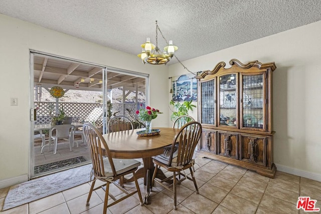 dining room featuring light tile patterned floors, a chandelier, and a textured ceiling