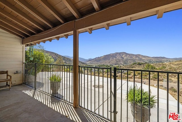 balcony with a mountain view and a patio