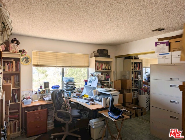 office area with a textured ceiling and carpet flooring