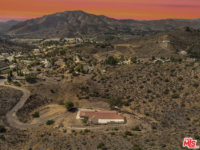 aerial view at dusk featuring a mountain view