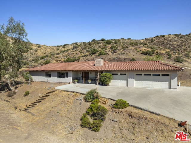 view of front facade featuring a garage and a mountain view