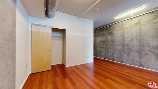 unfurnished room with hardwood / wood-style floors