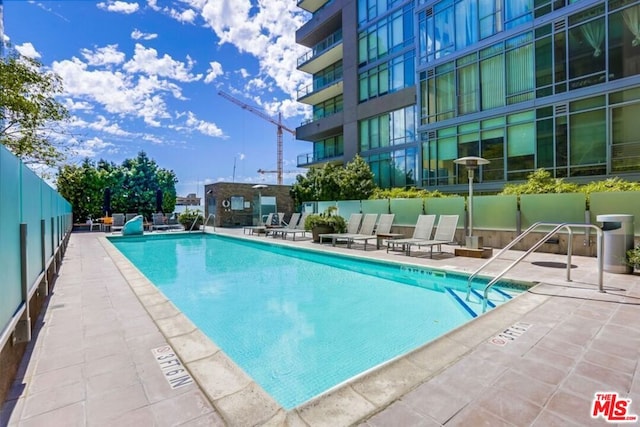 view of swimming pool with a patio