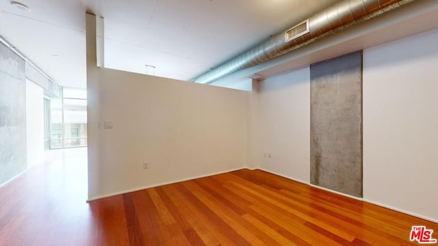 unfurnished room featuring hardwood / wood-style floors