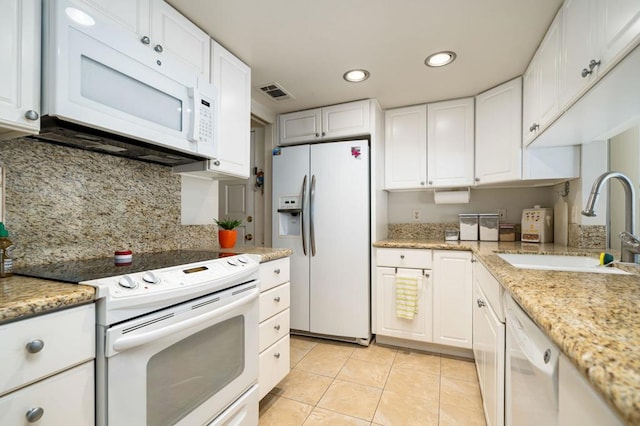 kitchen featuring white cabinetry, backsplash, white appliances, light tile patterned floors, and sink