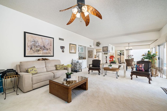 carpeted living room featuring a textured ceiling and ceiling fan with notable chandelier