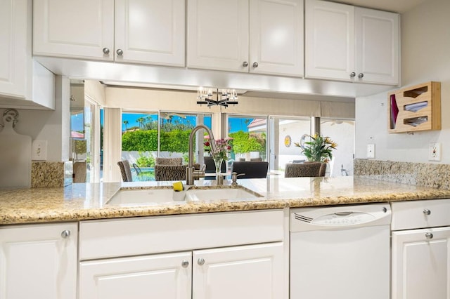 kitchen with white cabinets, dishwasher, and sink